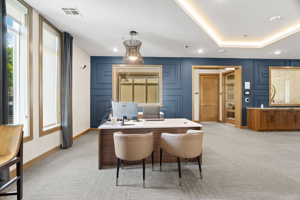 A modern office with a desk and chairs in the center.