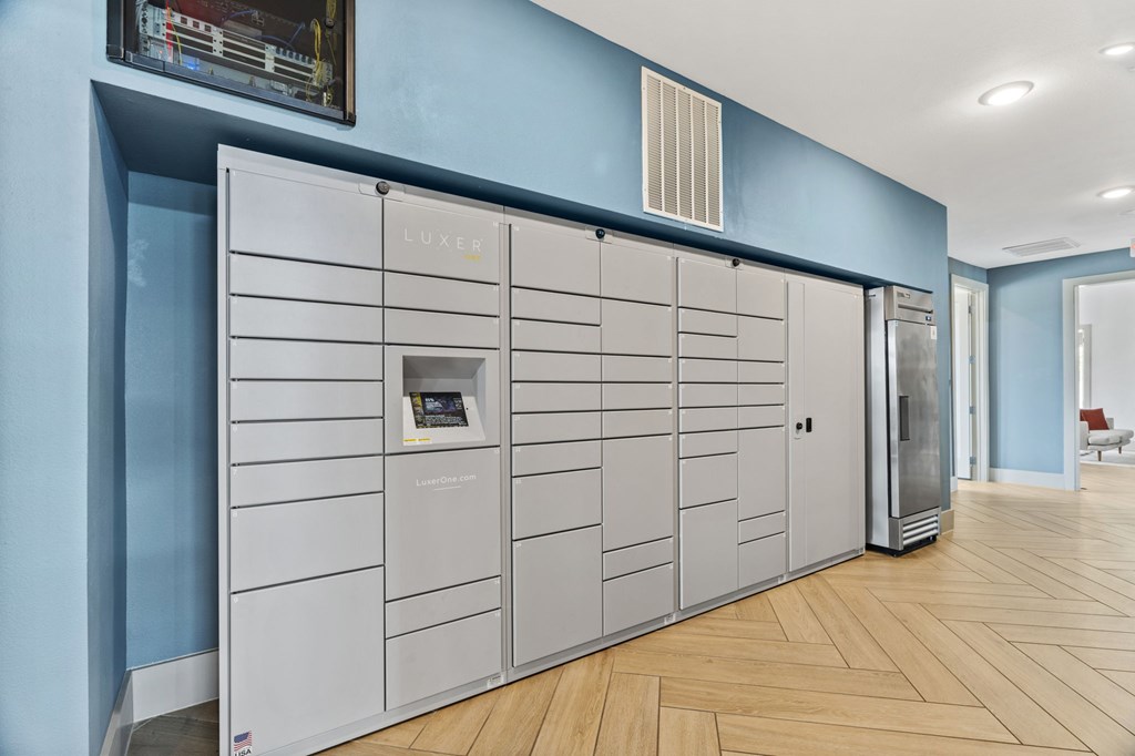A row of LUXER branded storage units in a room with wooden flooring.