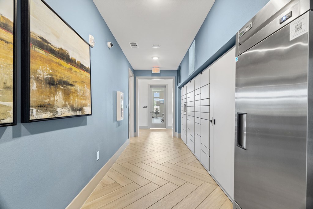 A long hallway with a refrigerator on the right.