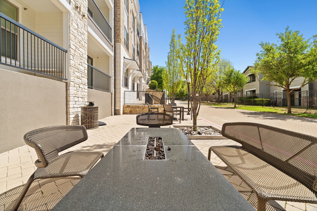 A view of a patio with a table and chairs.
