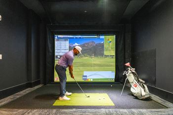 A man is playing golf in a virtual reality game.
