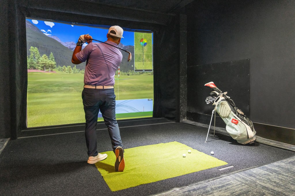 A man is playing golf in a virtual reality game.