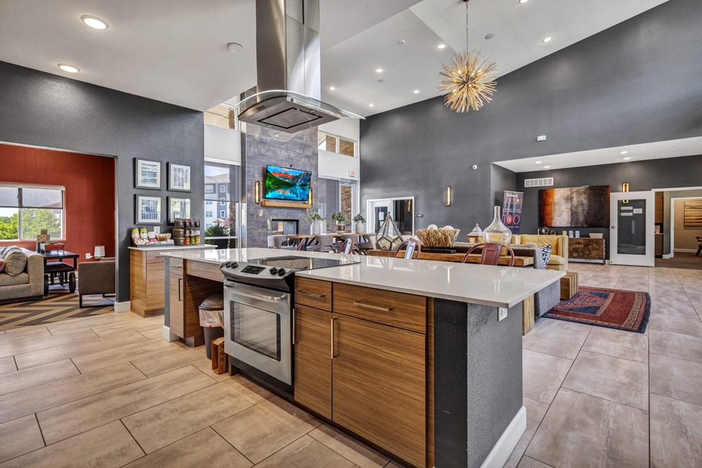 a kitchen with an island and a living room with a fireplace