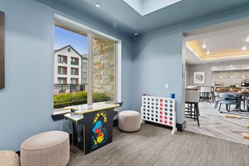 A room with a blue wall and a window showing a building outside.