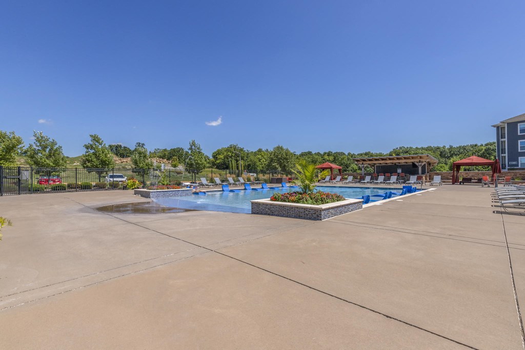 a swimming pool at a resort with a building in the background
