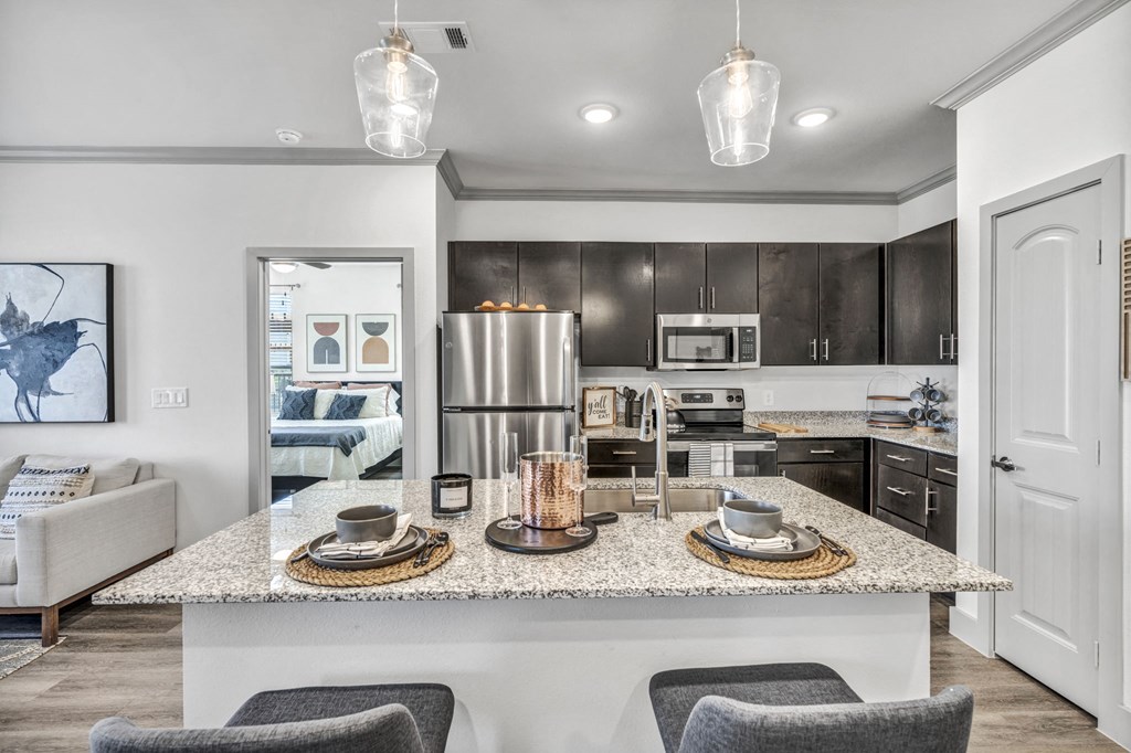 a kitchen with a granite counter top and a kitchen island