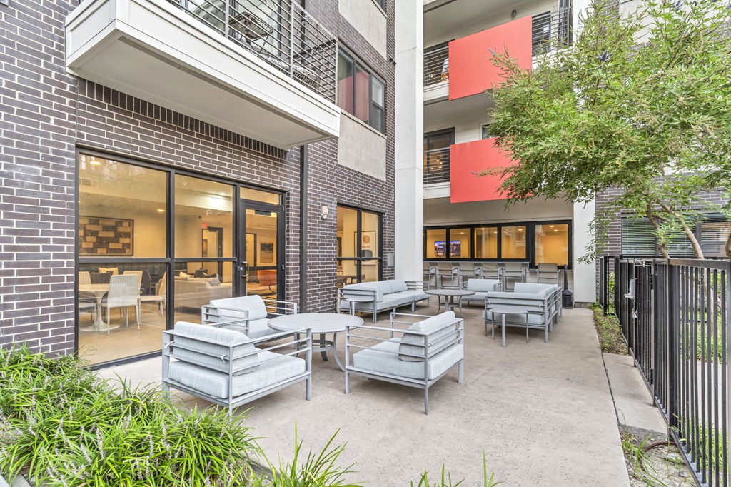 a patio with tables and chairs at the bradley braddock road station apartments