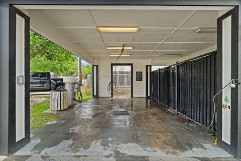 A parking garage with a concrete floor and a metal railing.