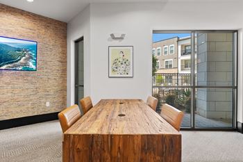 A conference room with a wooden table and chairs.