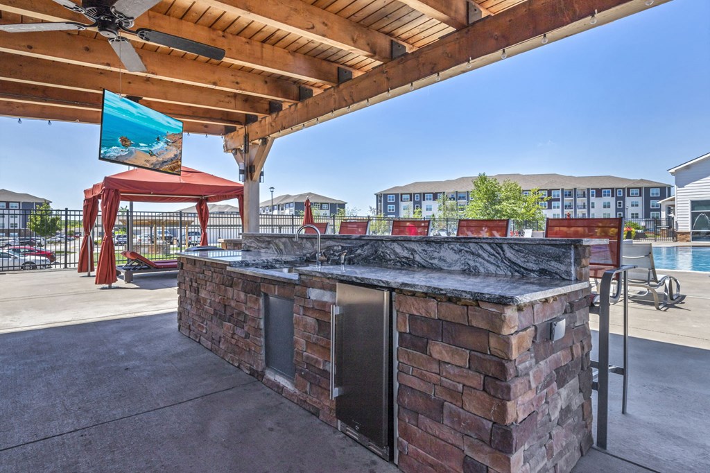 the clubhouse has a bar with a grill and a pool