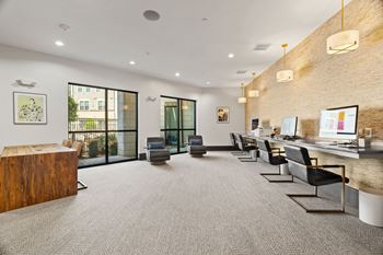 A modern office space with a wooden reception desk and comfortable seating.