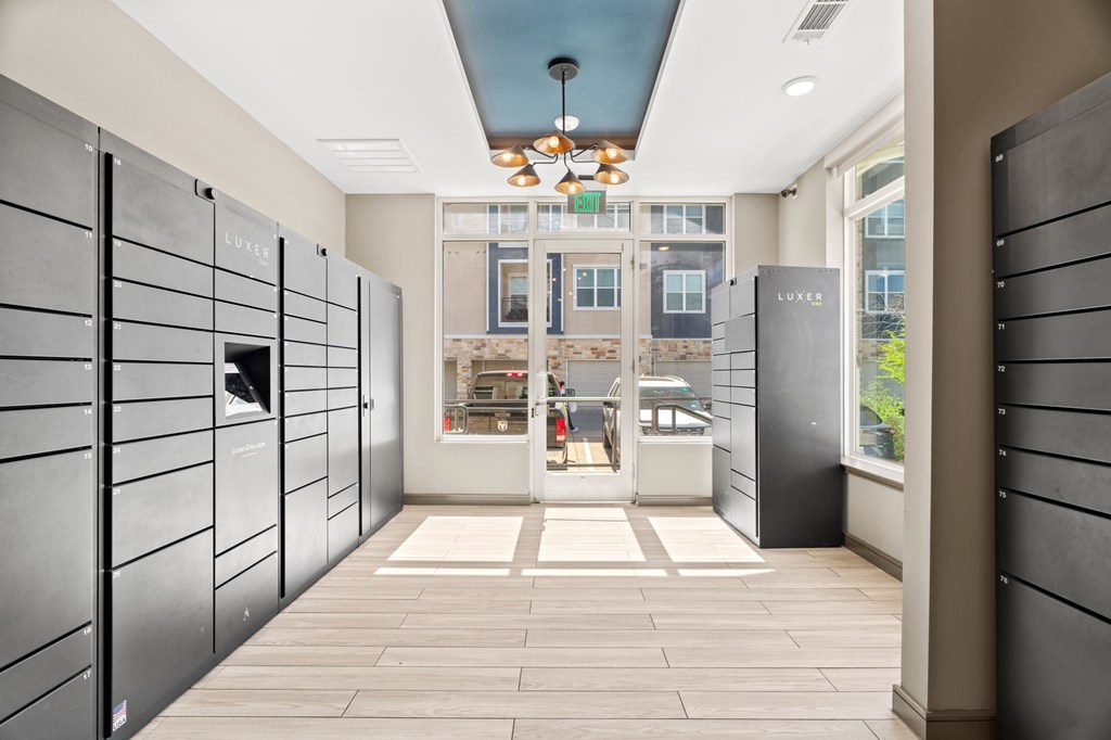 A hallway with a glass door and a sign that says "EXIT".