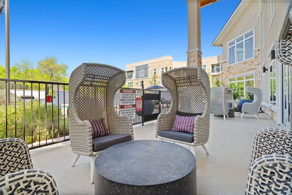 A patio with a table and chairs.