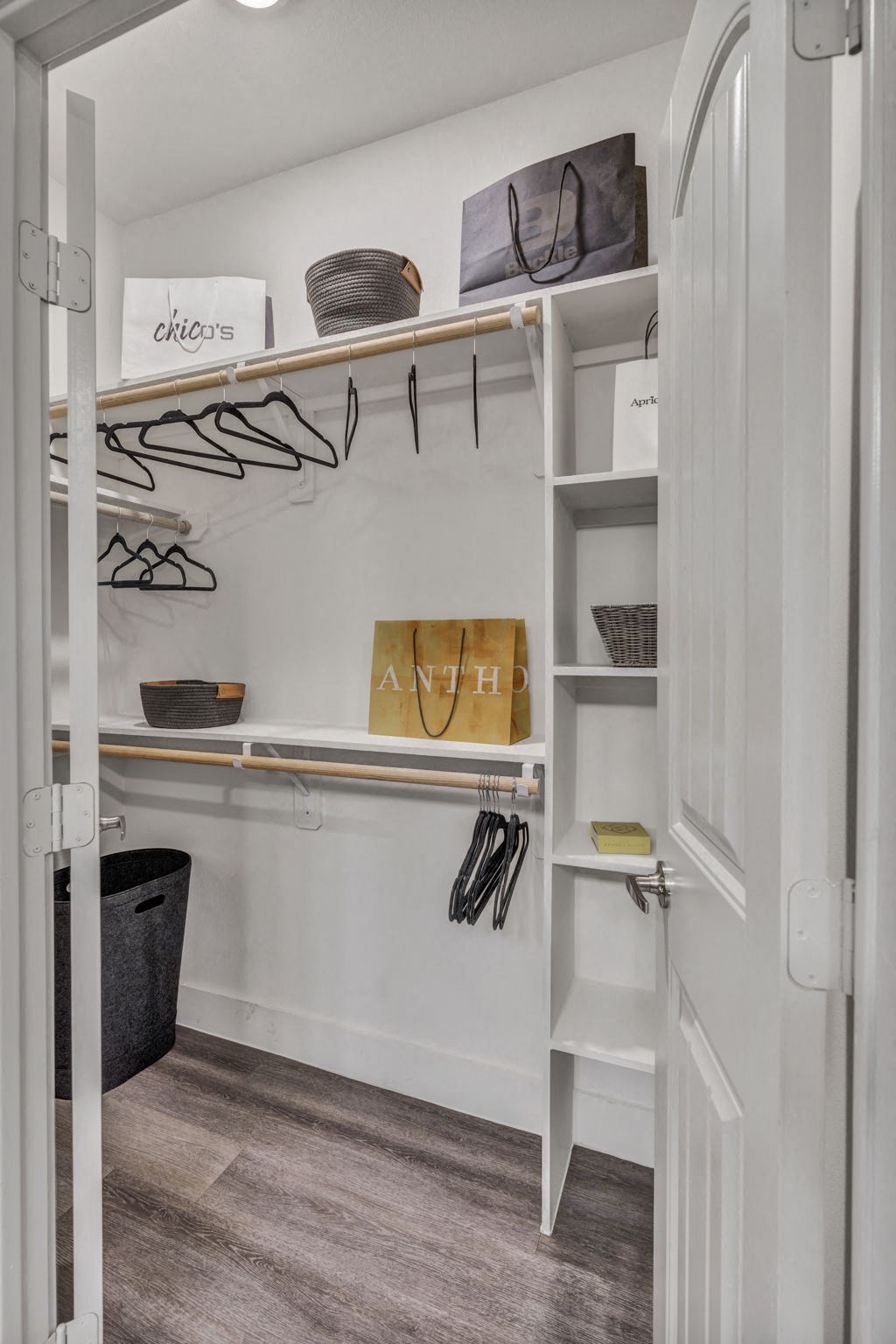 a walk in closet with shelves and hooks