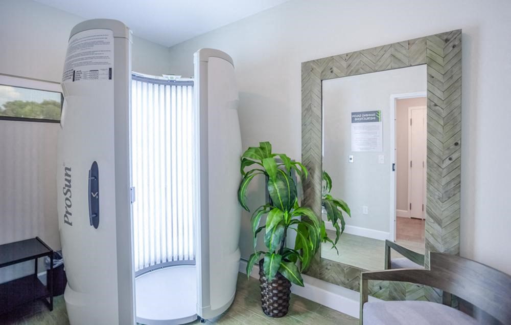a room with a large mirror and a shower and a plant