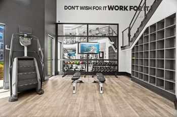 A gym with a sign that says "Don't wish for it, work for it".