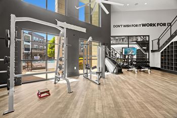 A gym with a variety of equipment including a treadmill, a bench, and a pull-up bar.