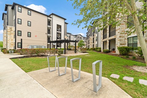 A modern apartment complex with a playground in front.