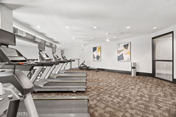A gym with treadmills and exercise equipment.