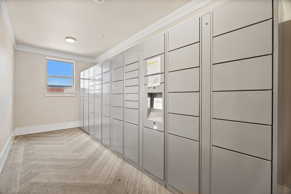 A hallway with a row of lockers on the right side.