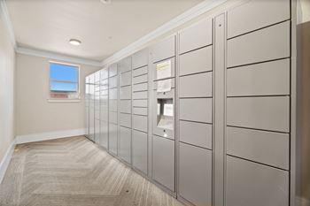 A hallway with a row of lockers on the right side.