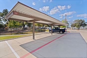 a car is parked at a gas station in a parking lot