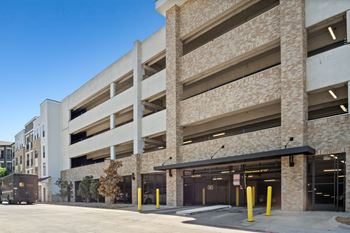 A parking garage with a clear blue sky in the background.