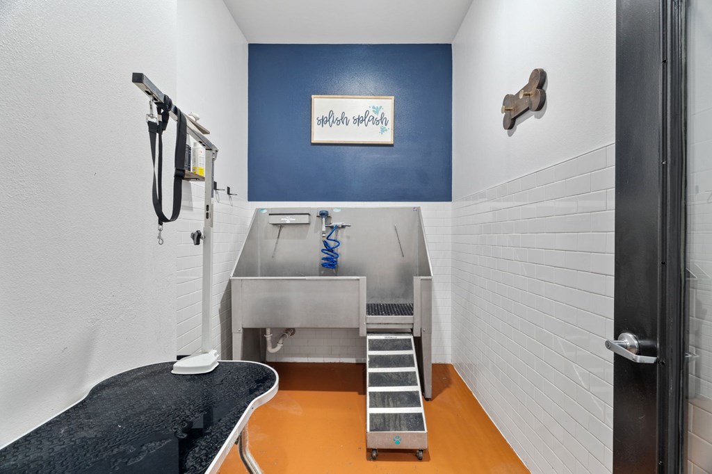 A room with a sink and a stairway.