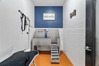 A room with a sink and a stairway.