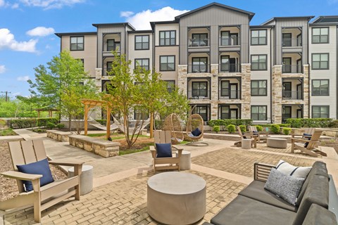 A large building with a patio in front of it.