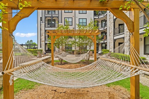 A hammock is suspended between two wooden posts.