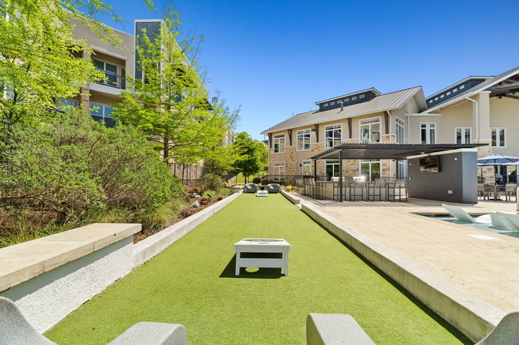 A modern building with a green lawn in front.