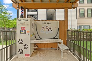 A pet spa with a sign that says "Axis Hamilton" is set up outside.