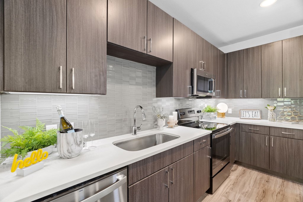 A kitchen with wooden cabinets and a white countertop.