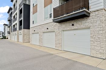 a building with white garage doors on the side of it