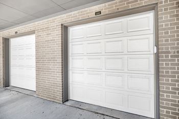 a pair of garage doors on a brick building