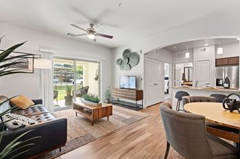 a living room with furniture and a ceiling fan