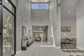 the lobby of a condo with a long hallway and a large window
