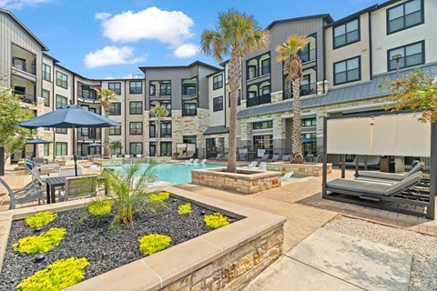 A sunny day at a resort with a pool and palm trees.