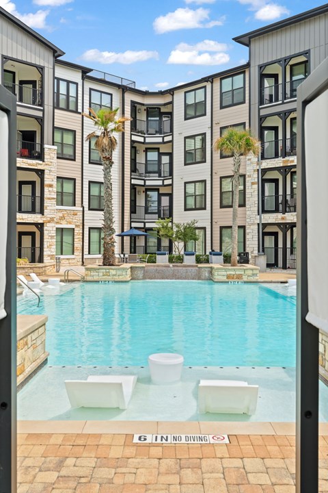 A pool with a no diving sign in the middle.