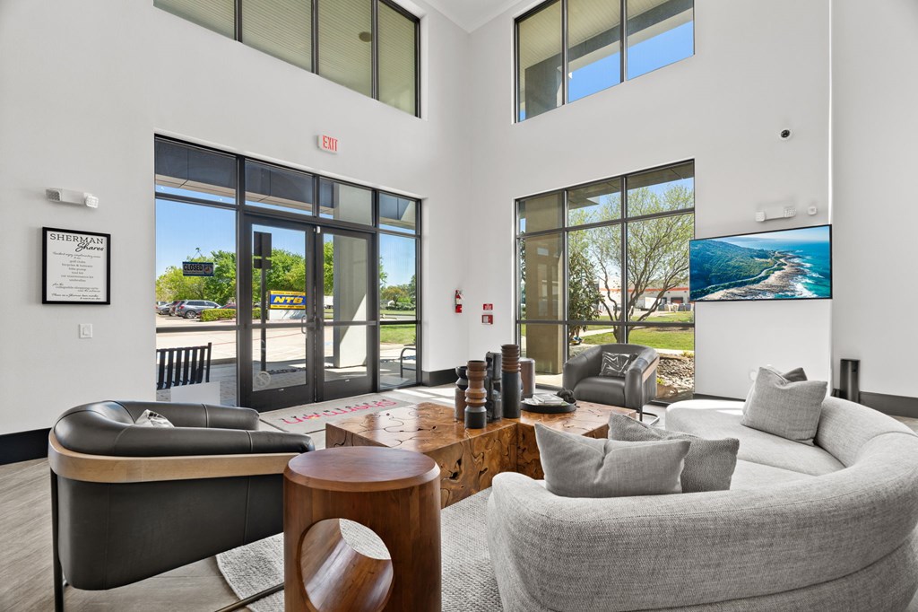 A living room with a grey couch and a black leather chair.