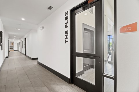 A hallway with a sign that says "The Flex" on the wall.