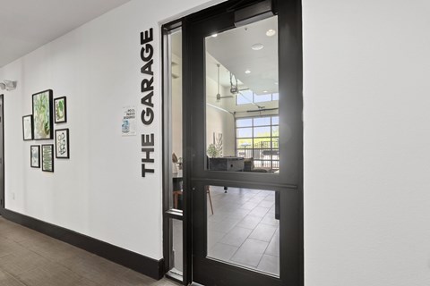 A white wall with THE GARAGE written on it.