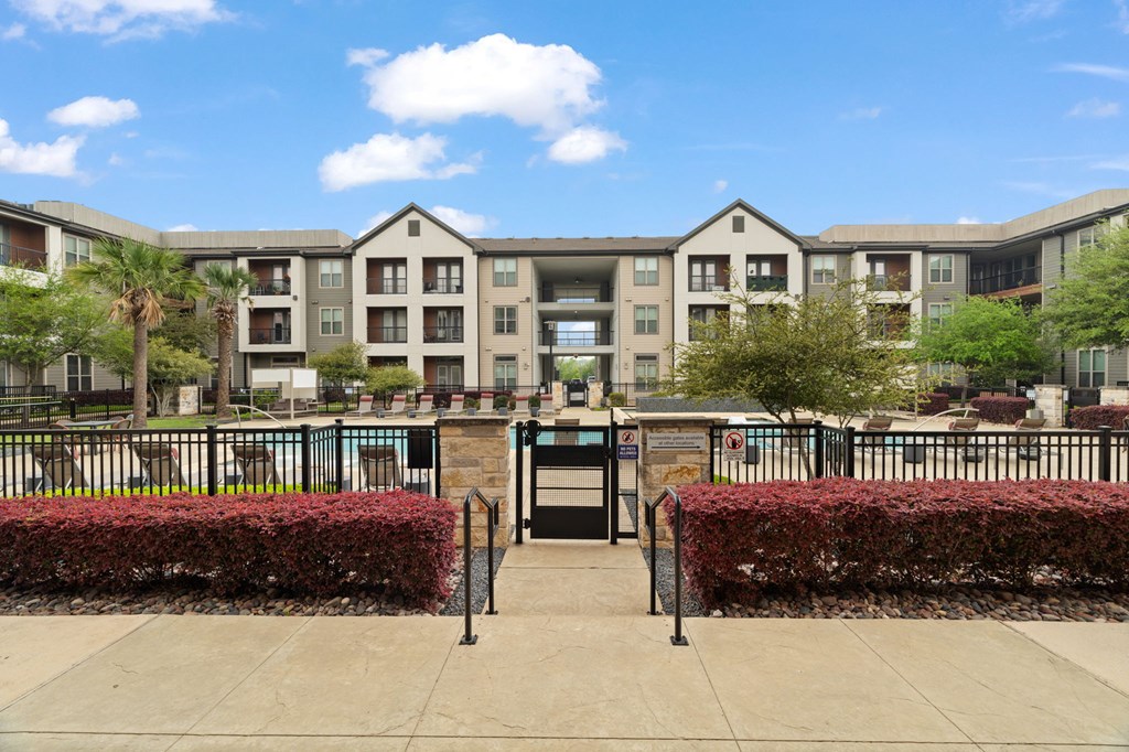 A building with a black gate in front of it.