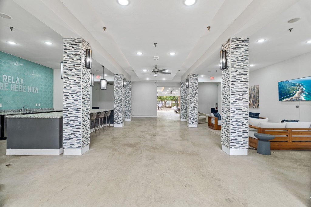 A spacious room with a long counter and a relax sign on the wall.