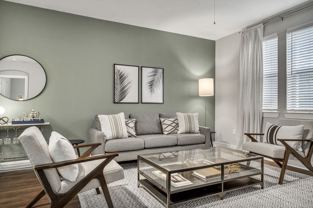 a living room with a couch and a glass coffee table