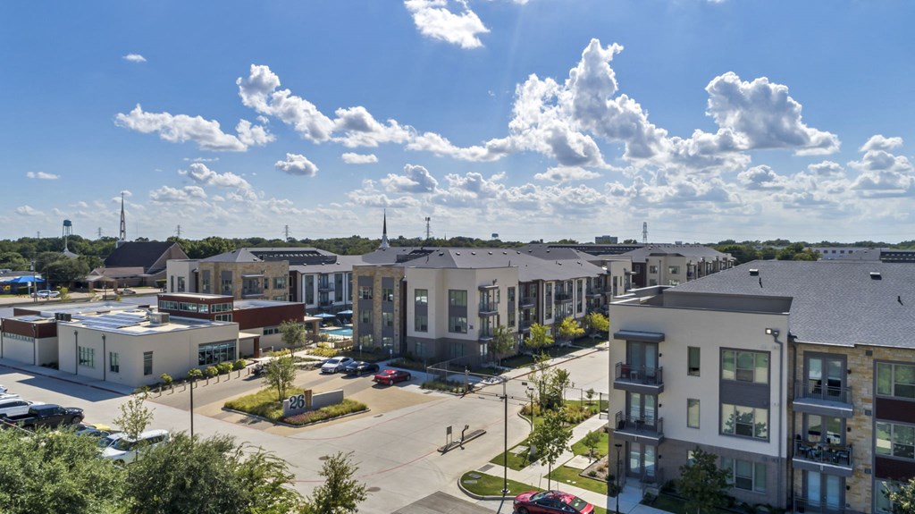 an aerial view of apartment buildings in a parking lot