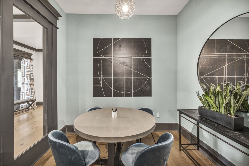 a dining room with a table and chairs and a large mirror