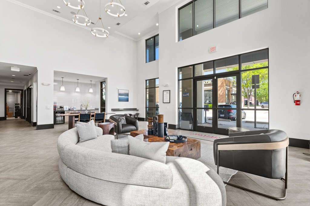 A modern living room with a curved sofa and a fireplace.