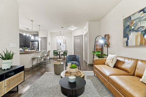 A living room with a brown leather couch and a black coffee table.